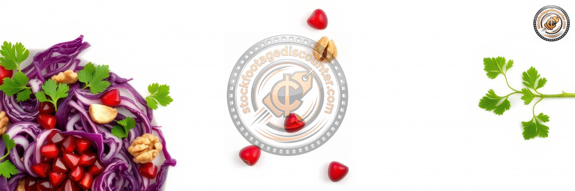 Colorful salad with red cabbage, pomegranate, walnuts, and fresh herbs arranged artistically on a white background