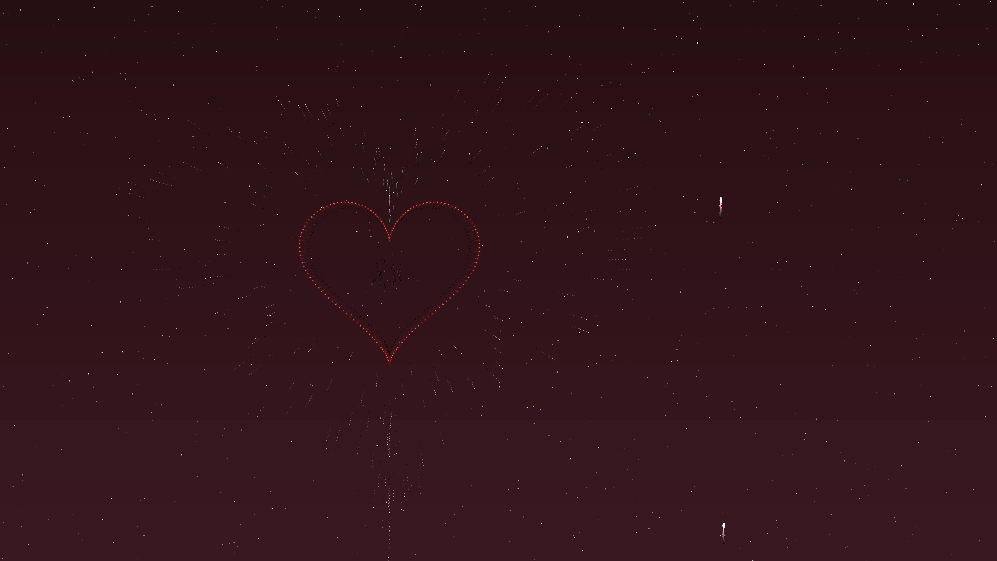 Colorful fireworks explode in the night sky with hearts for Valentines Day celebration
